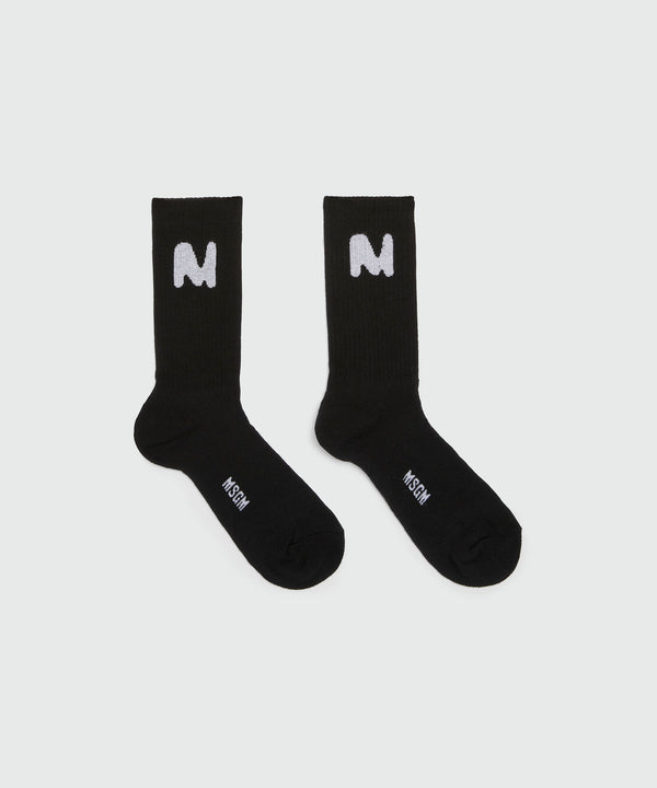 Black socks with "TheMwave" jacquard graphic