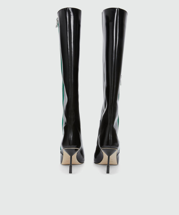 Black patent leather boots with green zipper