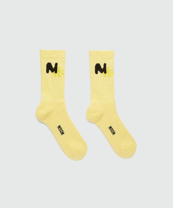 Yellow socks with "TheMwave" jacquard graphics