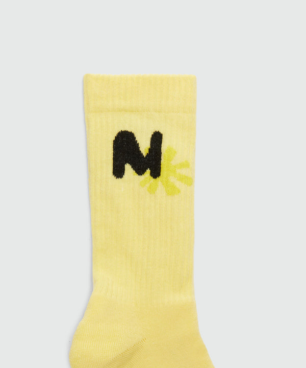 Yellow socks with "TheMwave" jacquard graphics