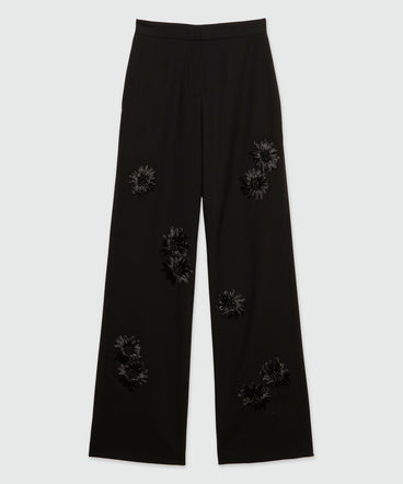 Wool trousers with raffia applications