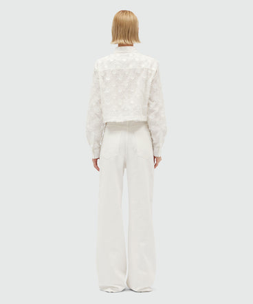 White denim trousers with raffia flowers