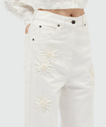 White denim trousers with raffia flowers