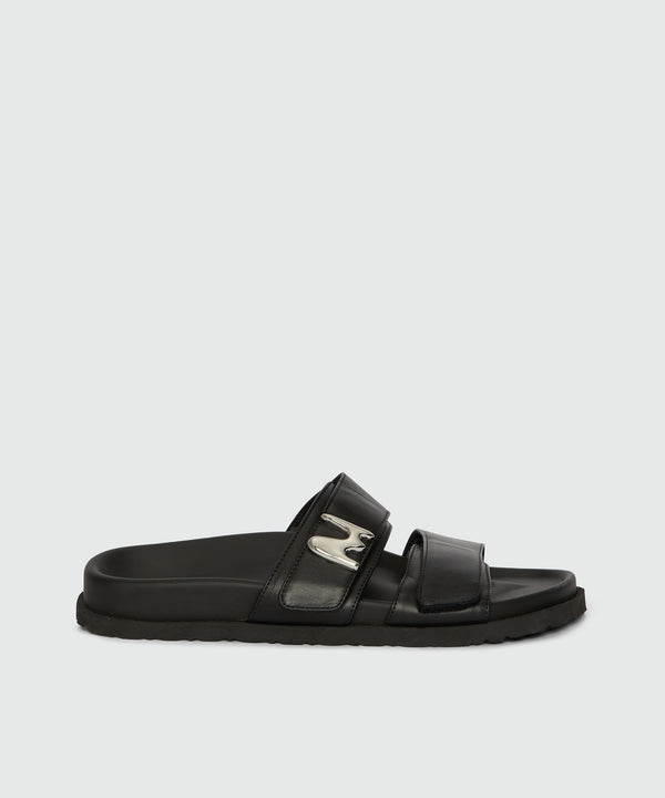 Flat sandals in black leather and "TheMwave" logo