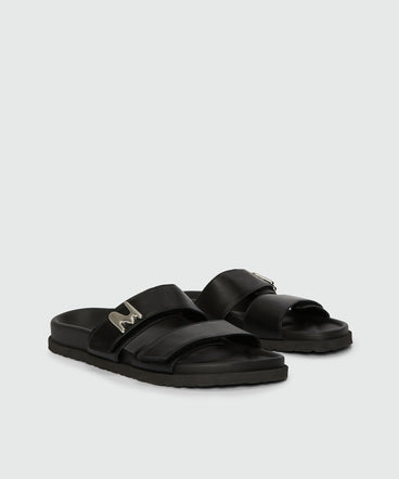 Flat sandals in black leather and "TheMwave" logo