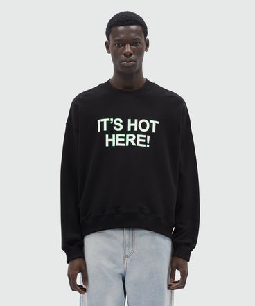 Black organic cotton sweatshirt with quotes "IT'S HOT HERE!"