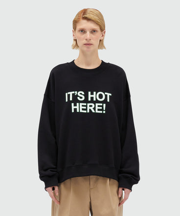 Black organic cotton sweatshirt with quotes "IT'S HOT HERE!"